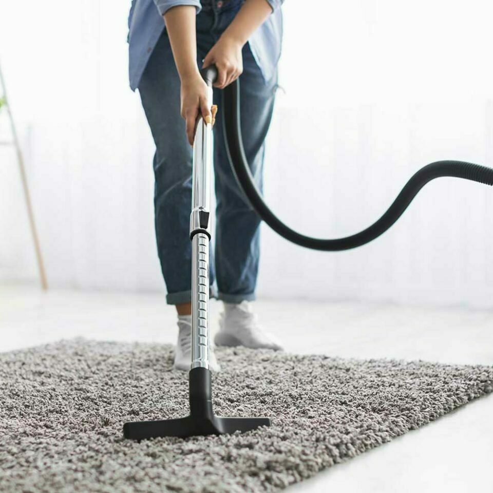 person vacuuming an area rug | Luna Flooring Gallery in Chicagoland, Oakbrook Terrace, Deerfield, Kildeer, and Naperville, IL