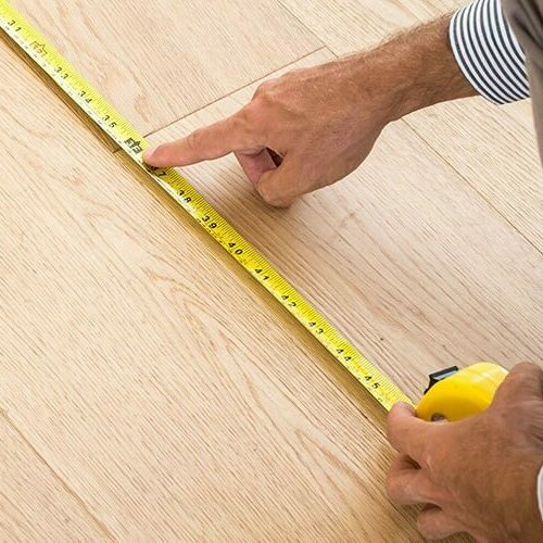 Man measuring floor | Luna Flooring Gallery