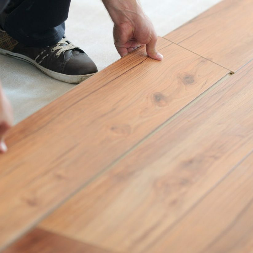 person installing laminate flooring | Luna Flooring Gallery in Chicagoland, Oakbrook Terrace, Deerfield, Kildeer, and Naperville, IL